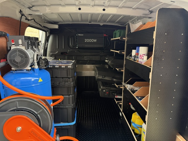 Inside the actual Glass and Trim Repair van with compressor, tool storage and fitted shelving